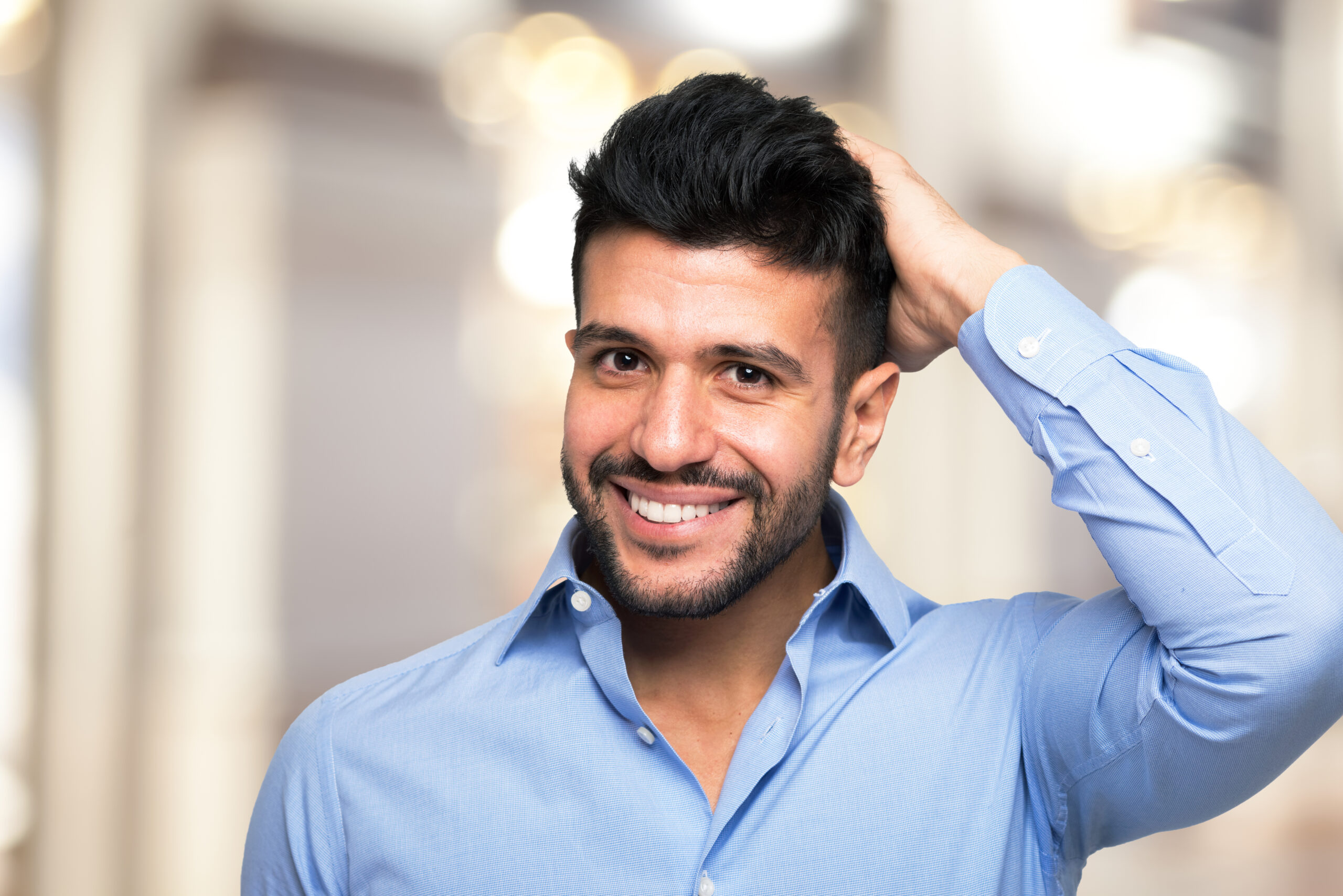 Portrait of a man touching his hair