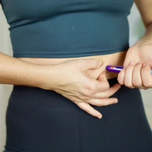 Woman injecting GLP-1 agonist into stomach