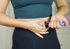 Woman injecting GLP-1 agonist into stomach