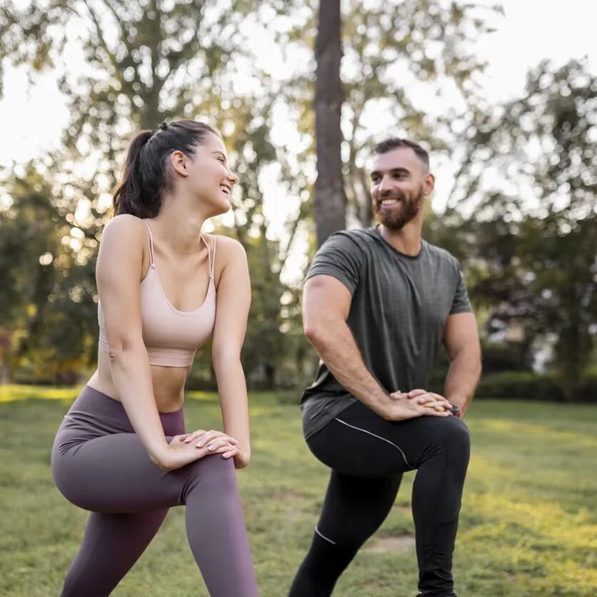 images_happy-people Two people stretching in a field together